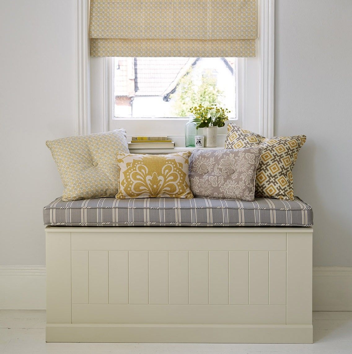 upholstered bench under window