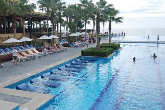 Lounge chairs in the pool - Picture of Hotel Riu