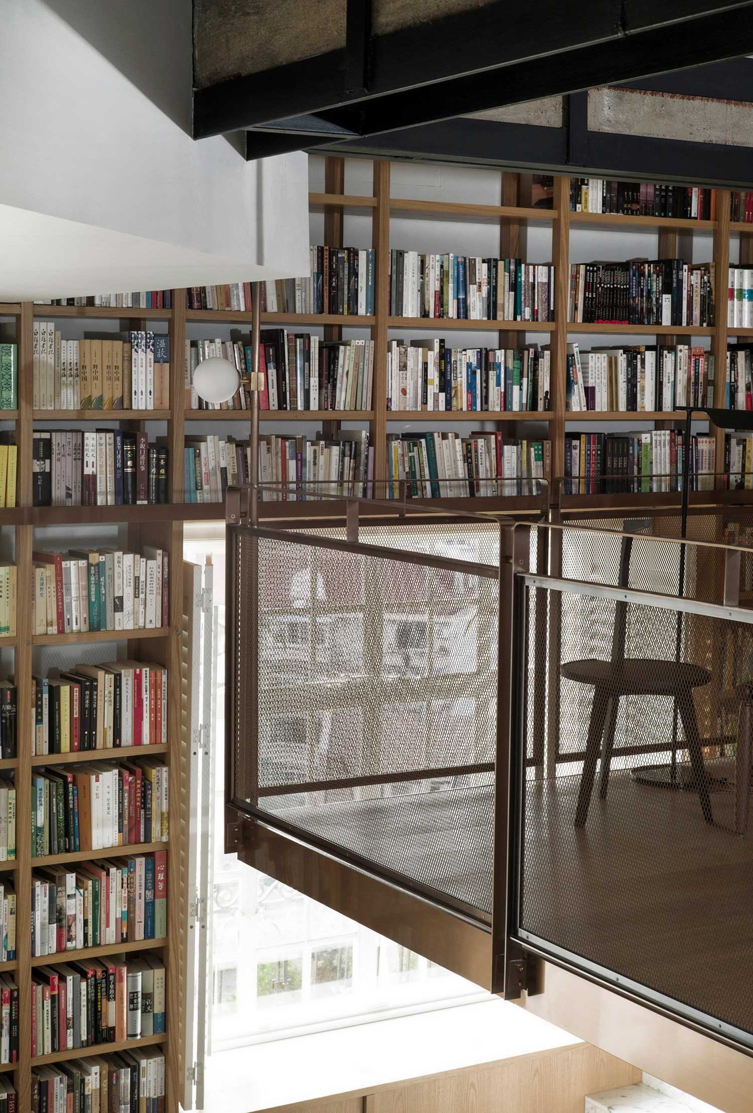 Shanghai Apartment Lined With Floor-To-Ceiling Bookshelves.