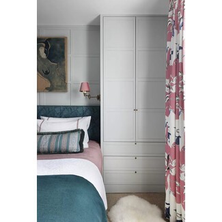 Airy coastal bedroom with white linens and rattan accents