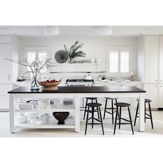 All-white Nantucket kitchen with black accents and natural materials