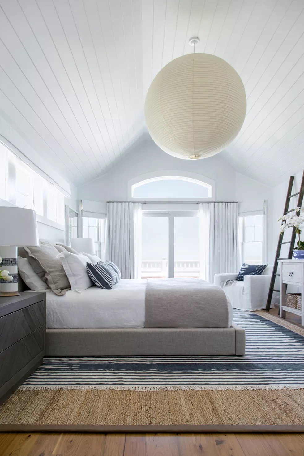 Beachfront bedroom with bright accents and panoramic windows