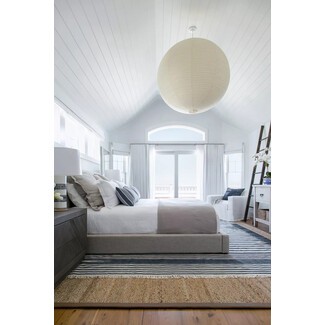 Beachfront bedroom with bright accents and panoramic windows