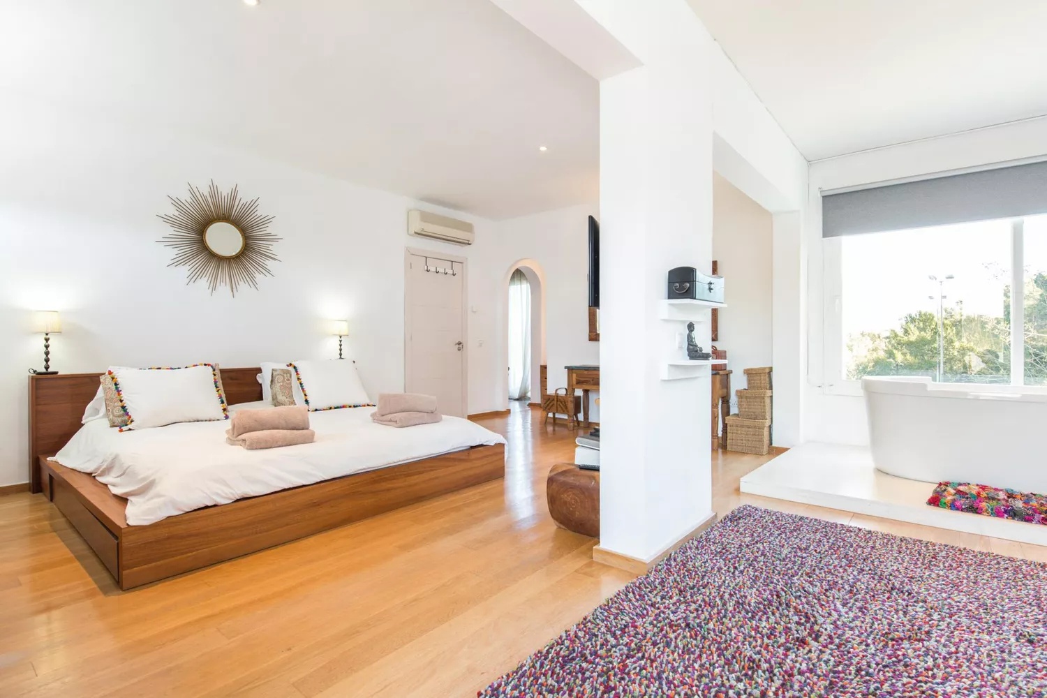 Bohemian style bedroom with canopy bed and patterned rug