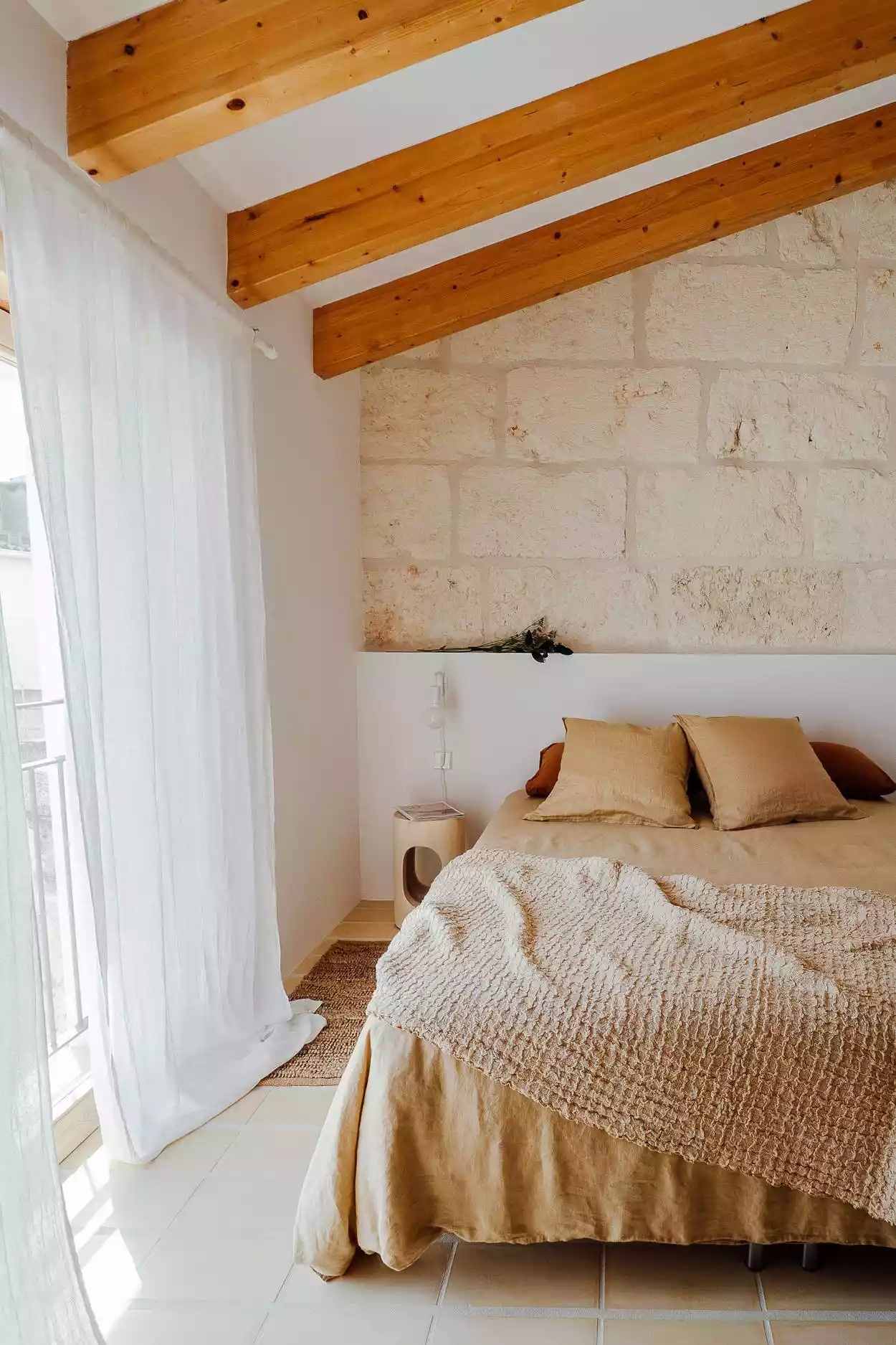 Bright bedroom with colorful accents and large windows