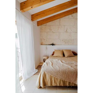 Bright bedroom with colorful accents and large windows