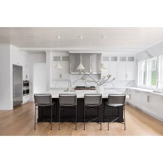 Light and airy white kitchen with black central island and silver-toned accents