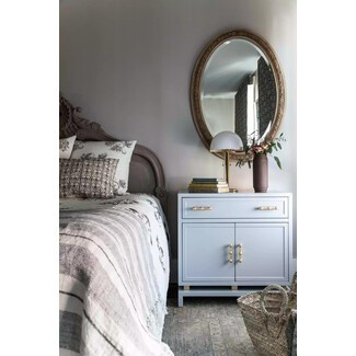 Coastal bedroom with blue accents and wooden side table