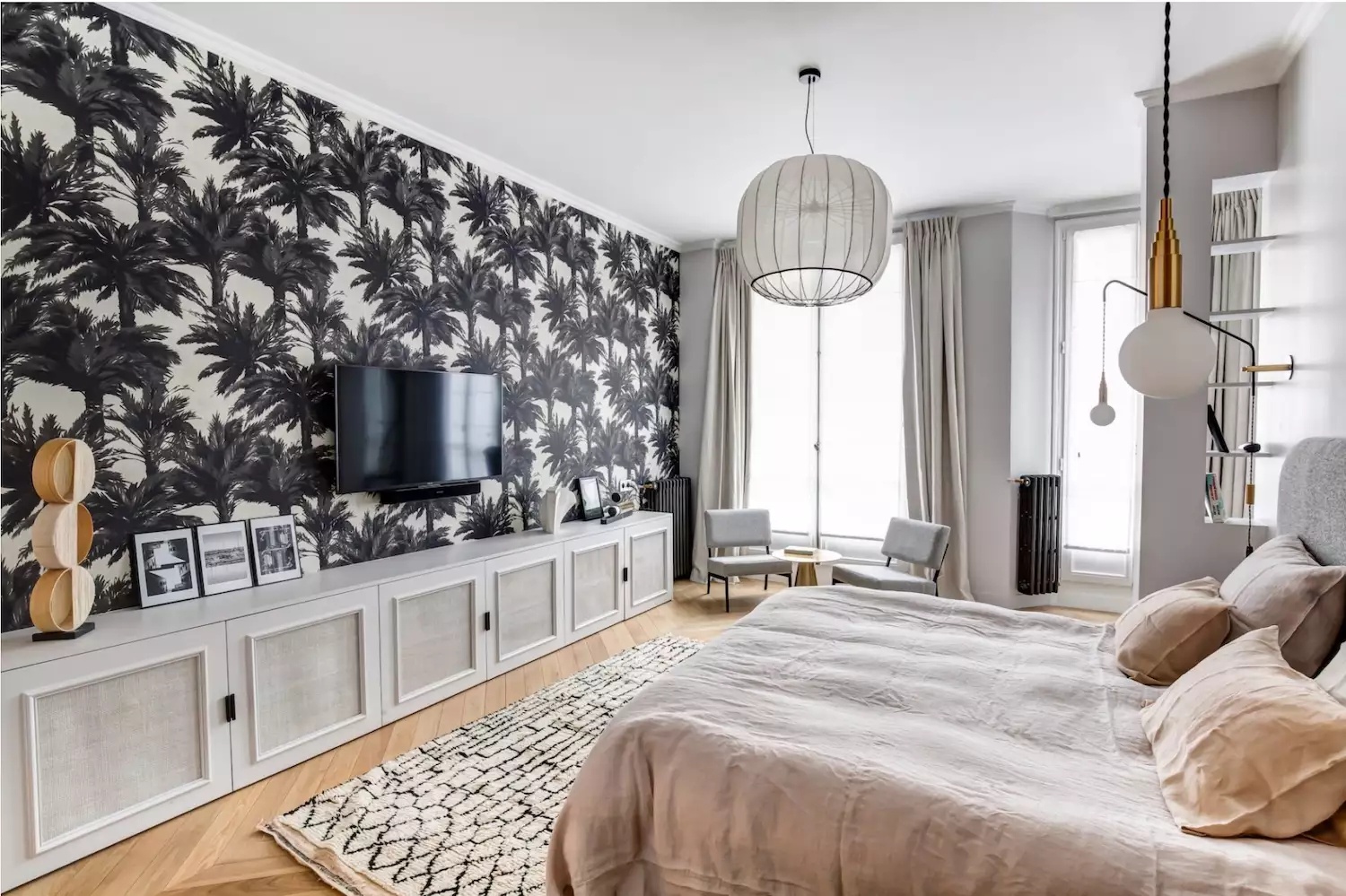 Contemporary bedroom with large window and unique chandelier
