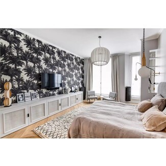 Contemporary bedroom with large window and unique chandelier