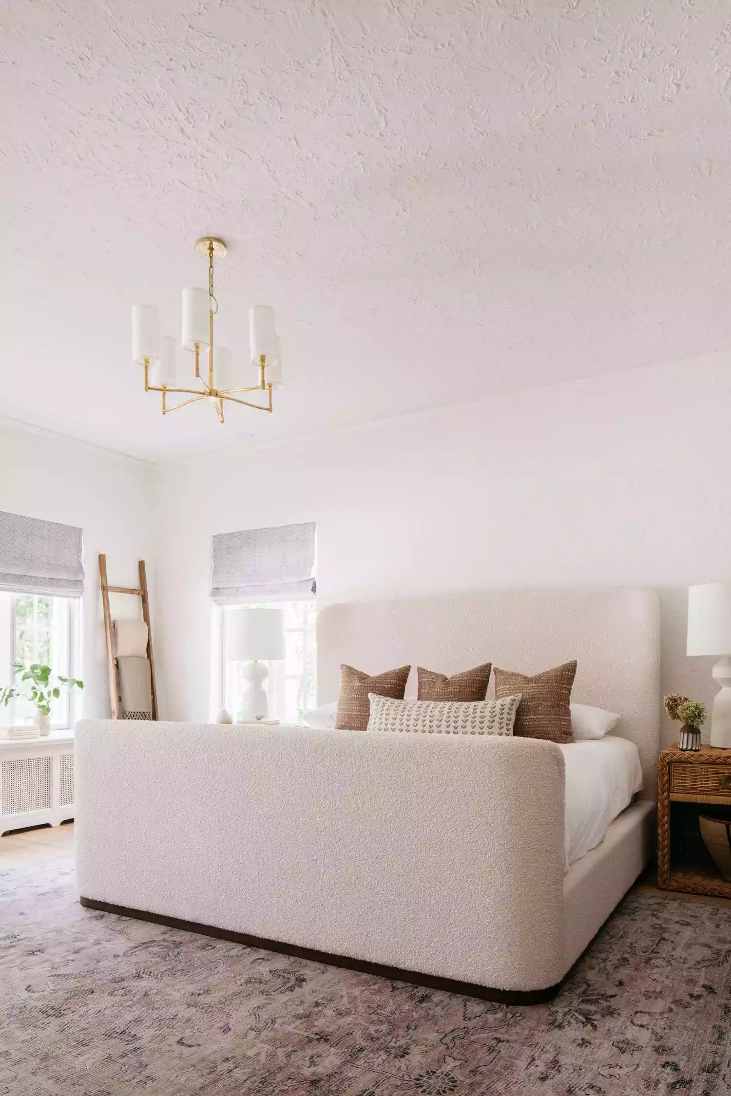 Contemporary bedroom with patterned wallpaper and unique lighting