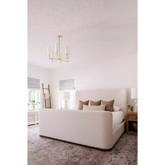 Contemporary bedroom with patterned wallpaper and unique lighting