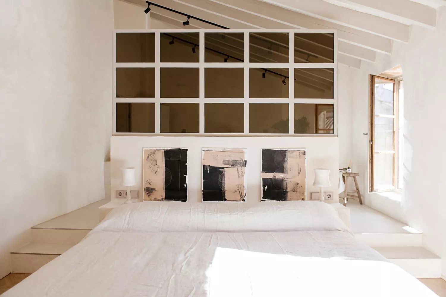 Contemporary bedroom with stone wall and unique lighting