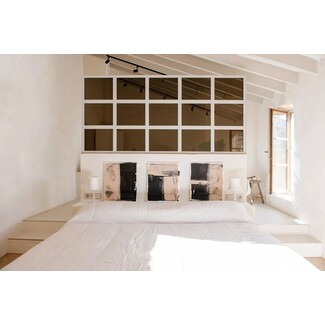 Contemporary bedroom with stone wall and unique lighting