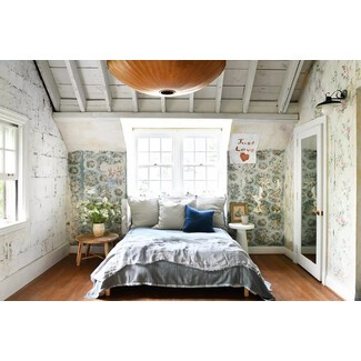 Cozy bedroom with white bedding and wooden beams