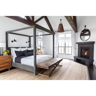 Cozy farmhouse bedroom with fireplace and exposed brick