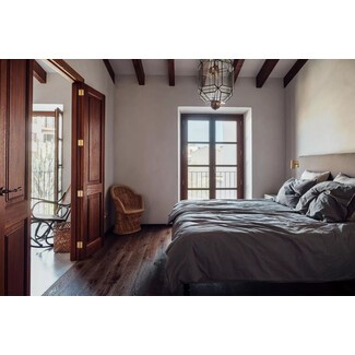 Eclectic bedroom with colorful artwork and patterned textiles