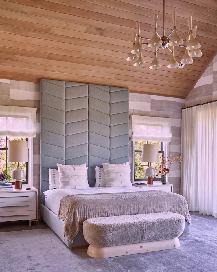 Eclectic bedroom with statement lighting and patterned headboard