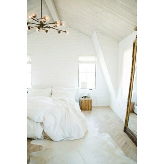 Eclectic boho bedroom with patterned textiles and plants