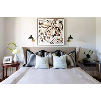 Elegant bedroom with blue velvet headboard and gold accents