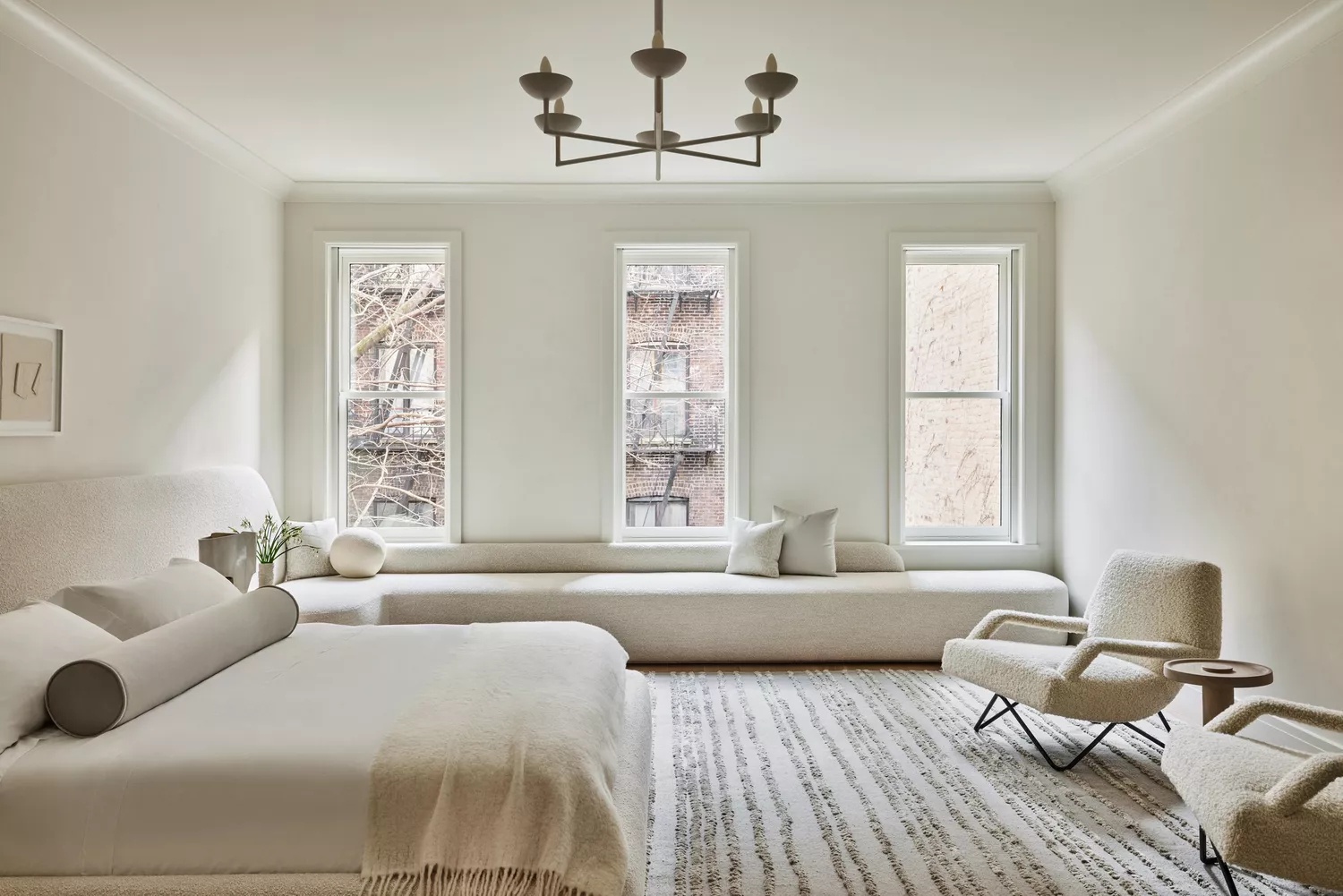 Elegant primary bedroom with fireplace and sitting area