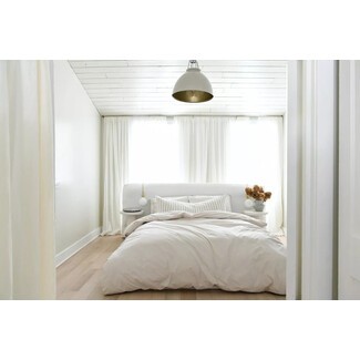 Farmhouse-inspired bedroom with rustic wooden beams