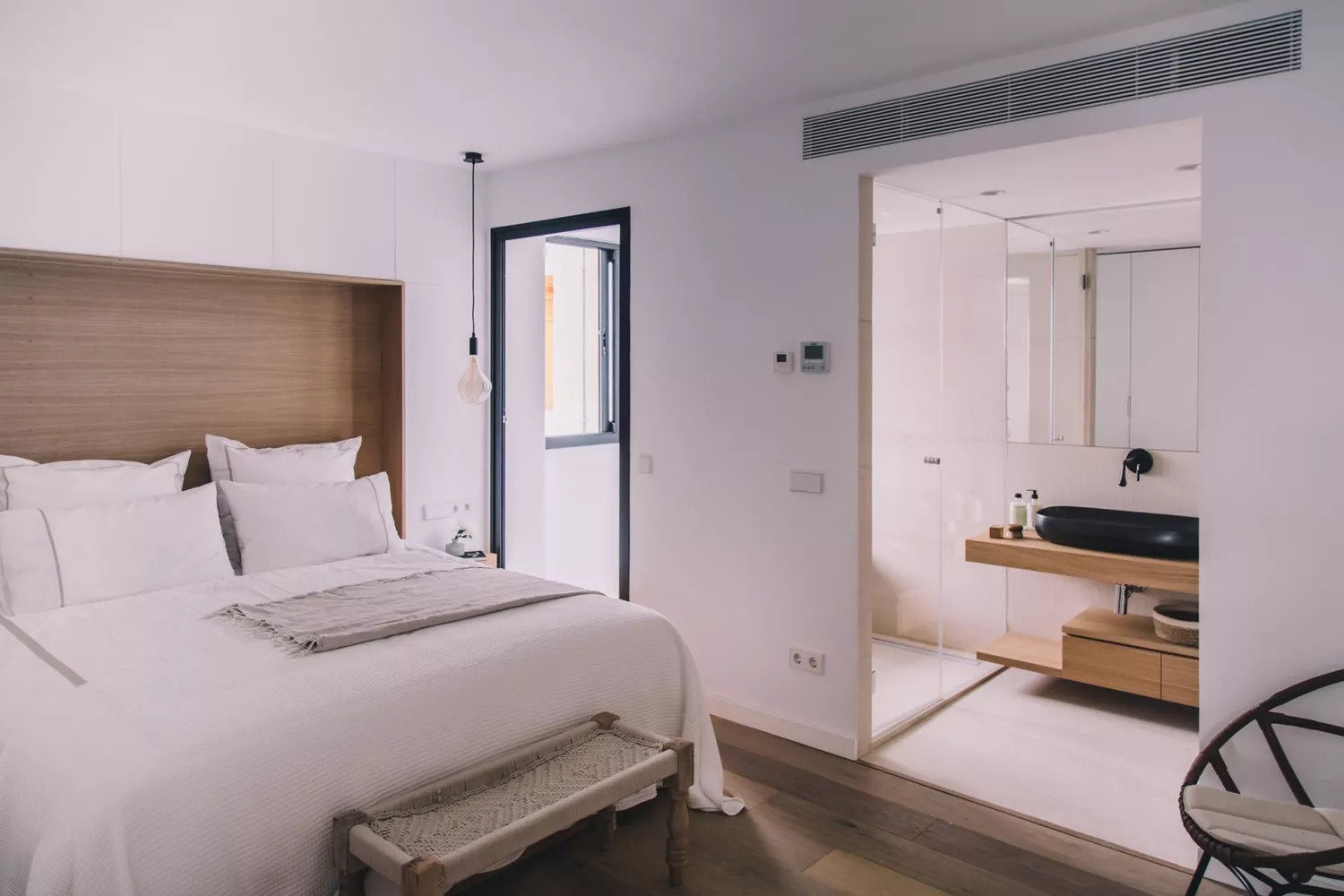 Stylish bedroom with green accents and plants