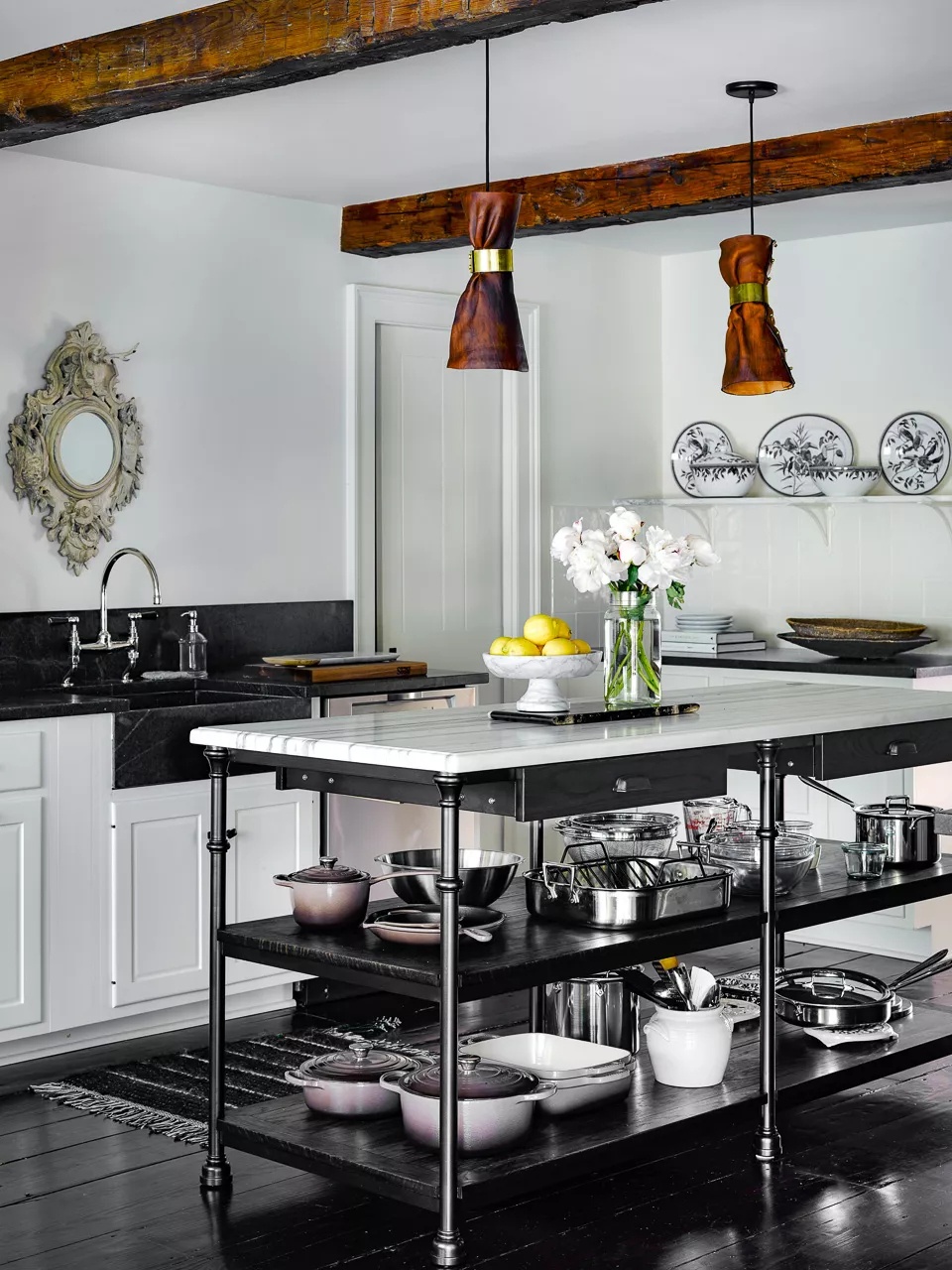 Layered black and white kitchen with modern and vintage elements and warm accents