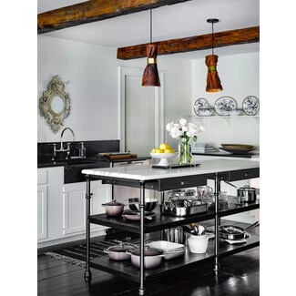 Layered black and white kitchen with modern and vintage elements and warm accents