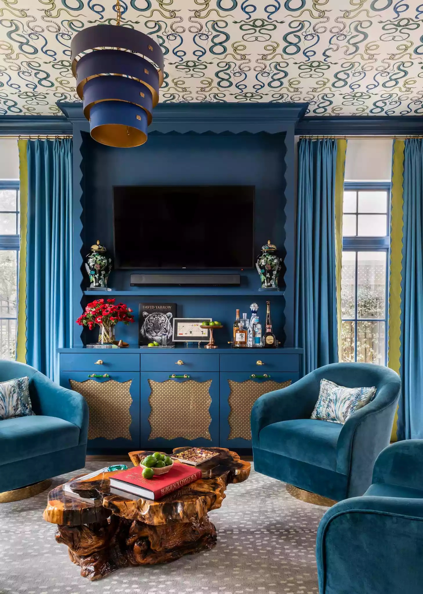 Playful room with scalloped pieces and geometric wallpaper