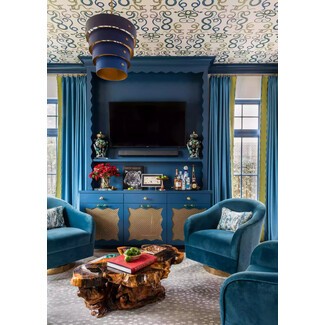 Playful room with scalloped pieces and geometric wallpaper