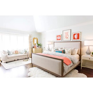 Luxurious bedroom with chandelier and tufted headboard