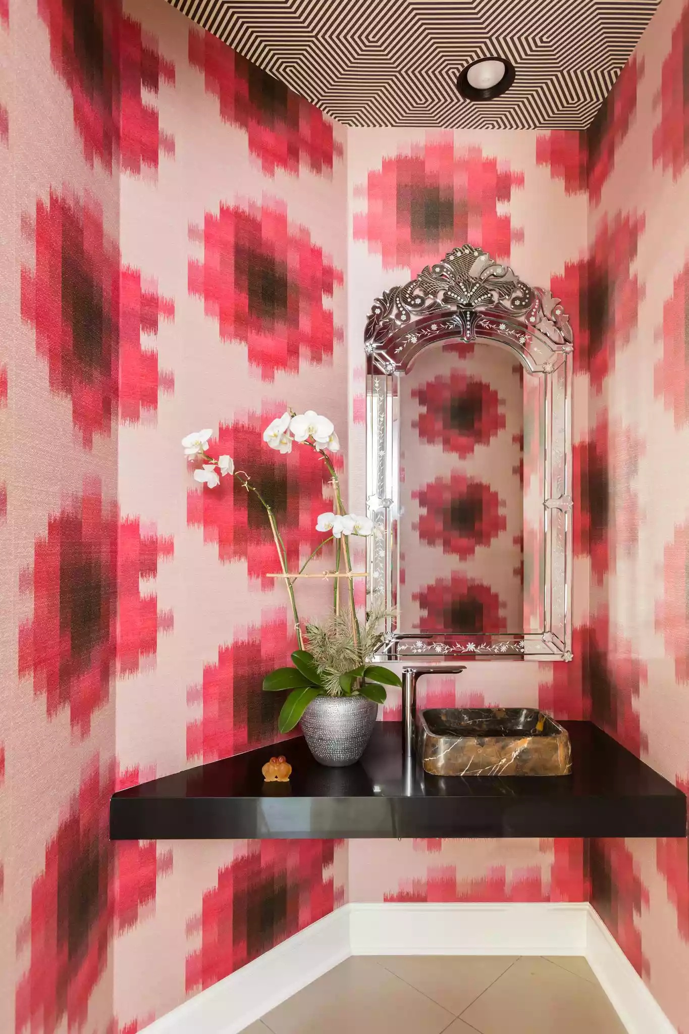 Maximalist black and white striped powder room