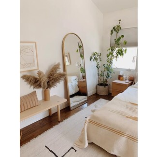 Minimalist bedroom with white bed and wooden floor