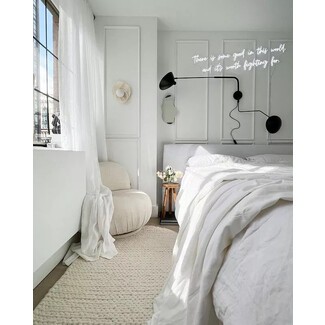 Modern bedroom with black accent wall and plants