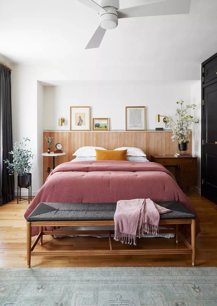 Modern bedroom with black accent wall and wooden floor