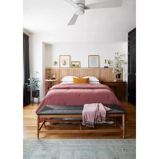 Modern bedroom with black accent wall and wooden floor