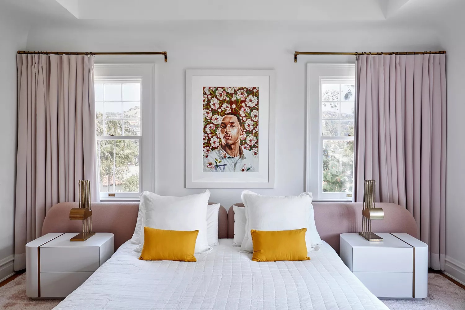 Modern master bedroom with colorful accents and white linens