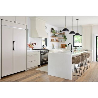 Modern family kitchen with subtle black accents and pale hardwood flooring