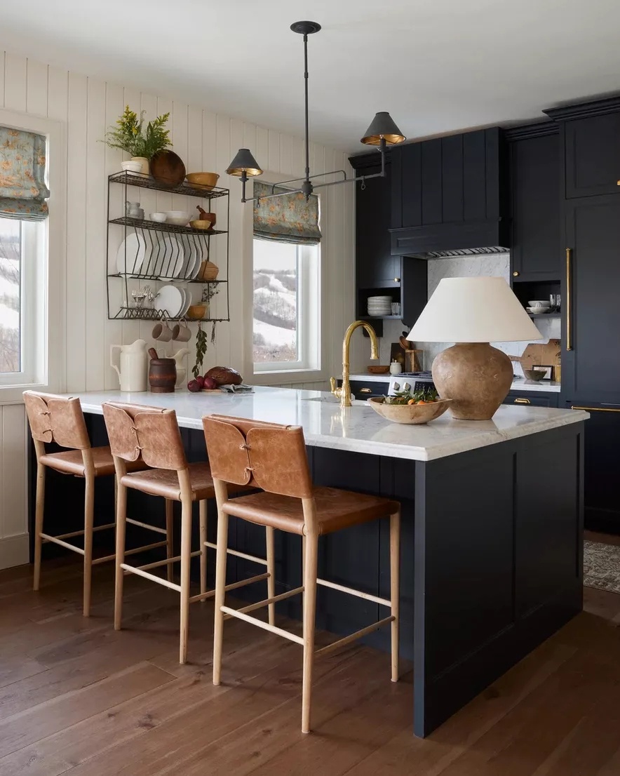 Modern farmhouse kitchen with deep blue-black island and white shiplap walls