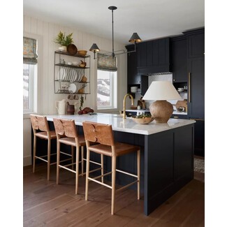 Modern farmhouse kitchen with deep blue-black island and white shiplap walls