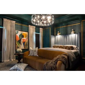 Moody green bedroom with eclectic decor