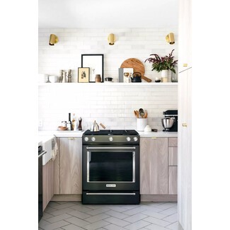 Open shelving in rustic green kitchen