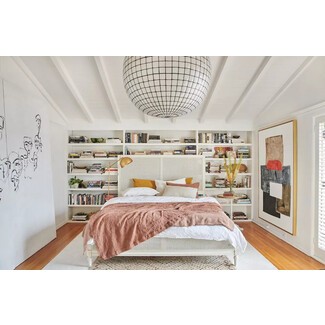 Rustic chic bedroom with exposed beams and white linens