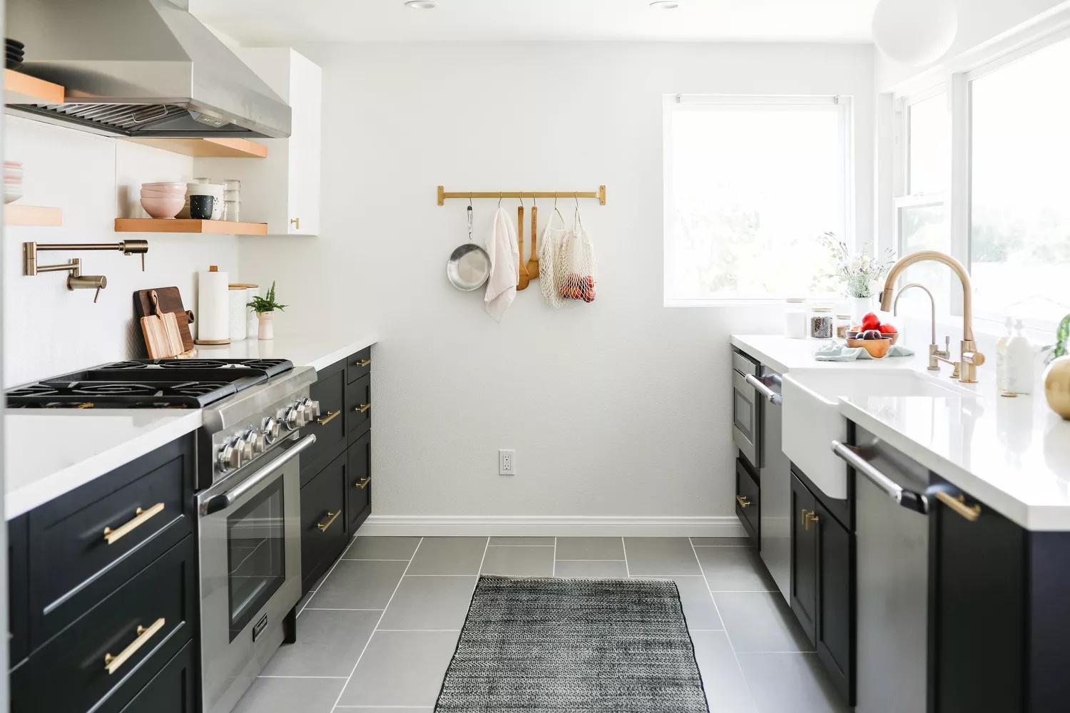 Minimalist Scandi-inspired galley-style kitchen with black-and-white palette and mixed metal finishes