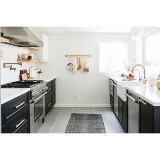 Minimalist Scandi-inspired galley-style kitchen with black-and-white palette and mixed metal finishes
