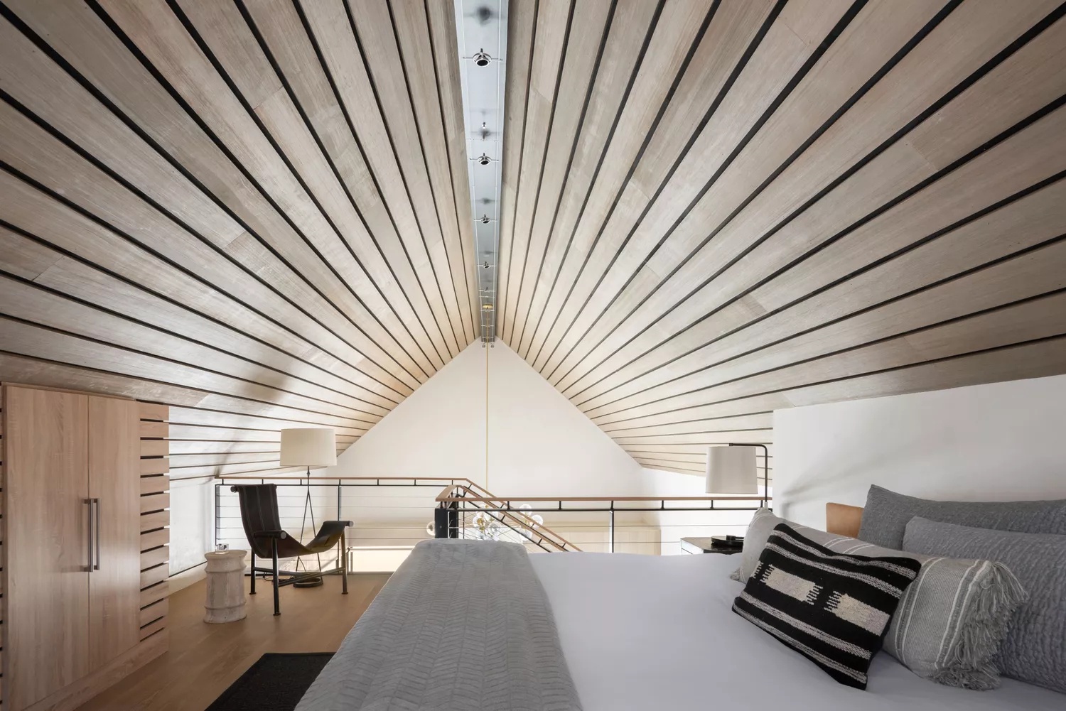 Minimalist slatted wood on curved loft ceiling