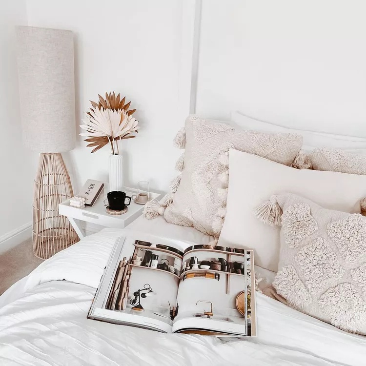 Small living room with white furniture and gallery wall