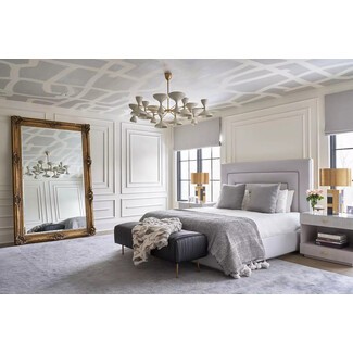 Sophisticated bedroom with textured walls and patterned rug