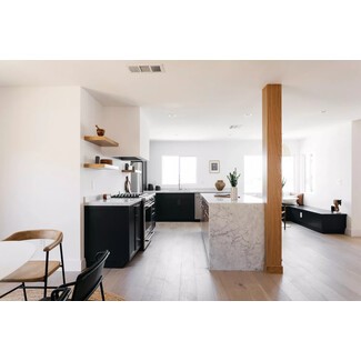 Black-and-white Southern California kitchen with light and airy feel and painted black lower cabinets